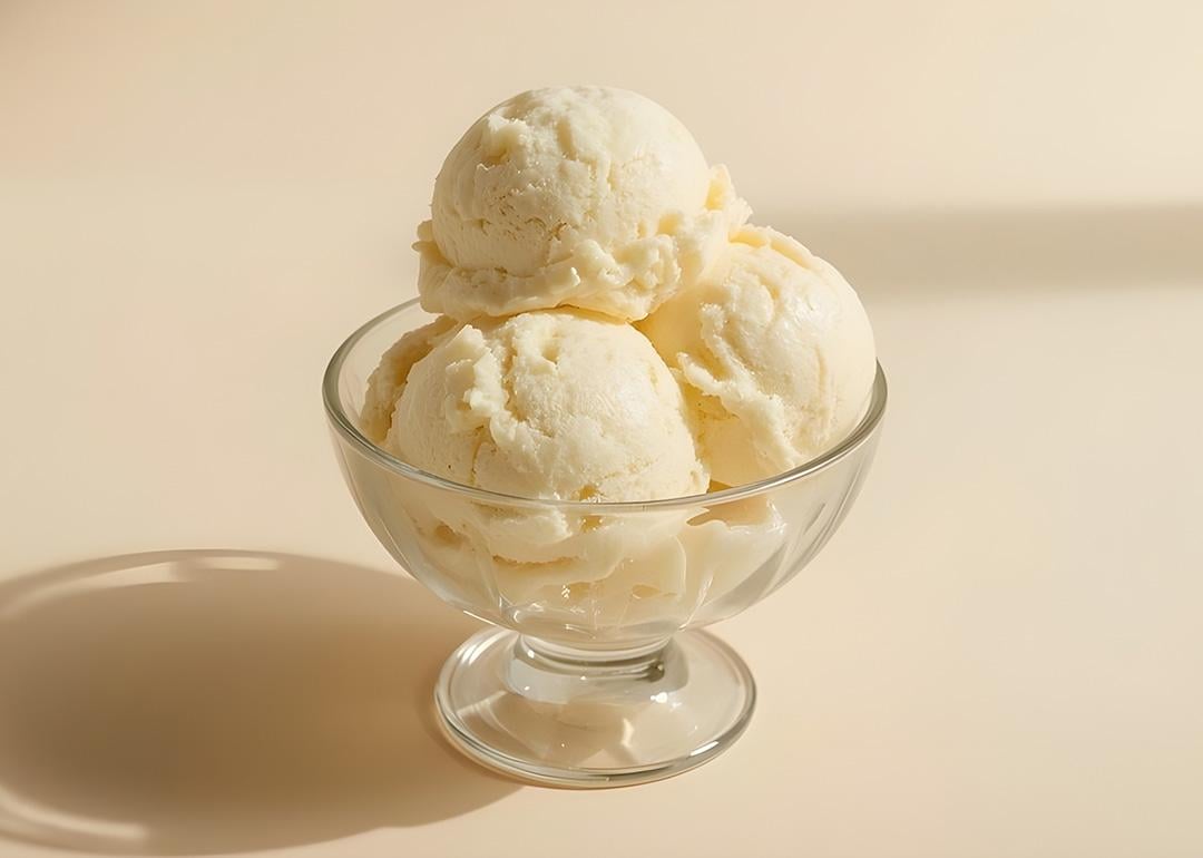Premium vanilla ice cream scoops placed in a glass bowl. 
