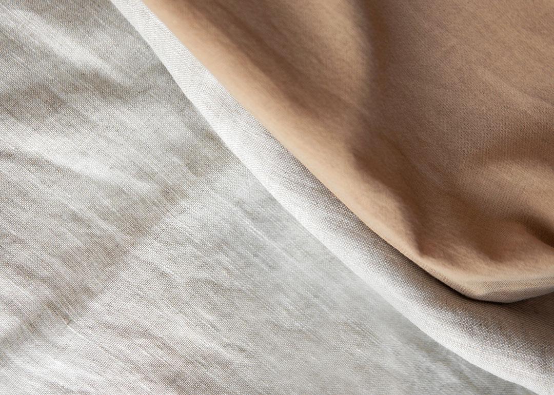 Folded linen cloths spread in a textured background.