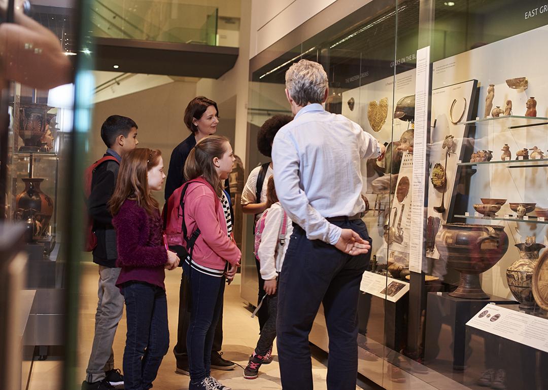 Students looking through artifacts during a museum visit. 
