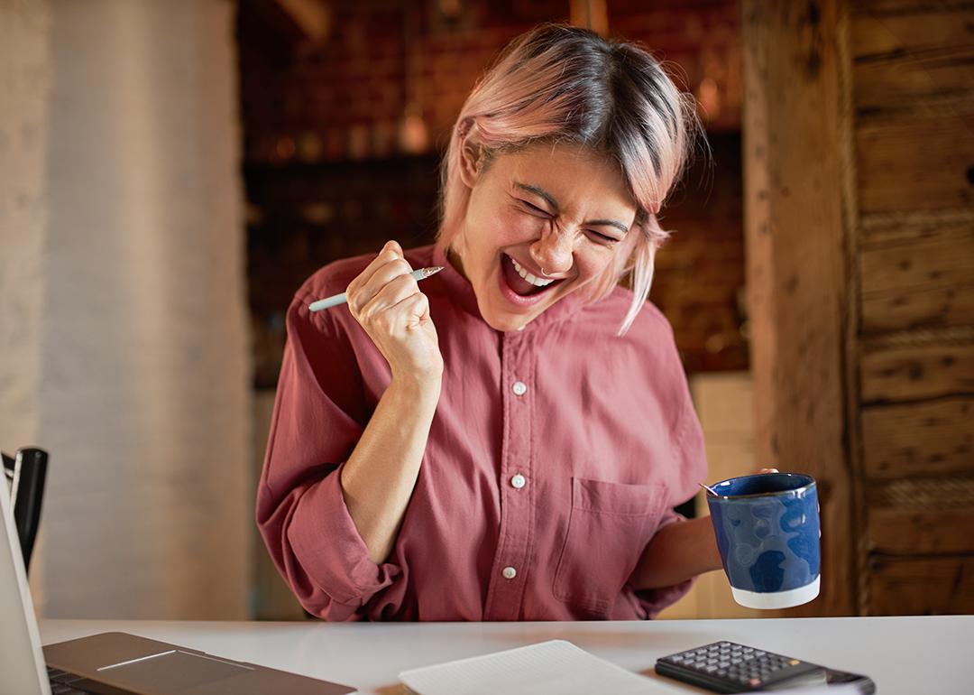A young adult appearing to be overjoyed after finally paying off debts. 
