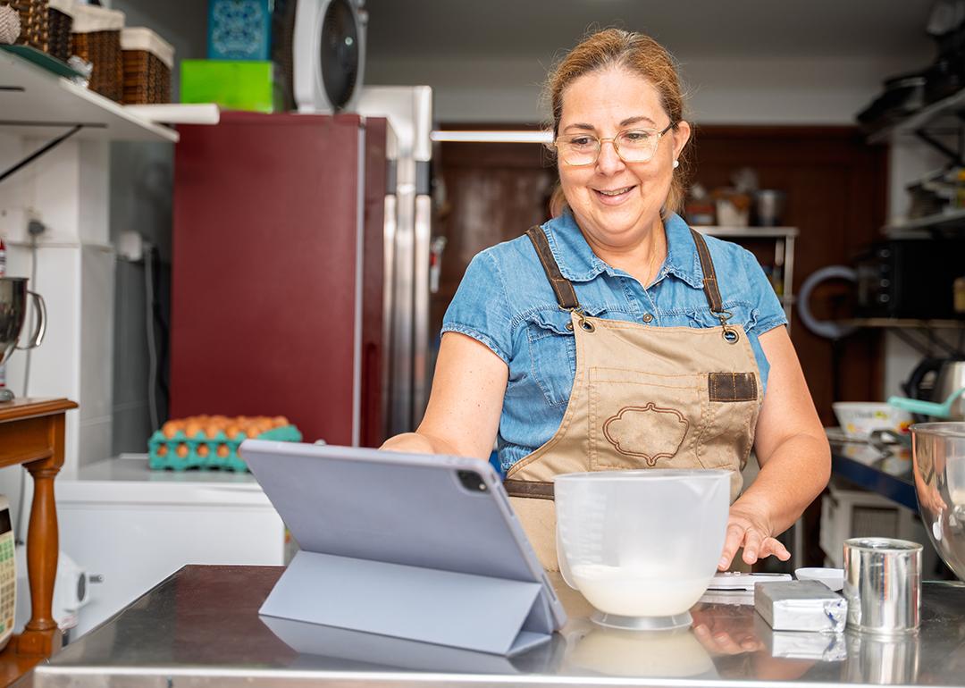 A pastry small business owner happily checking daily sales.