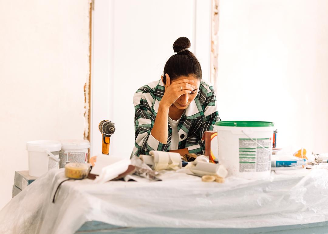 A young adult appearing to be tired from doing house painting and repairs.