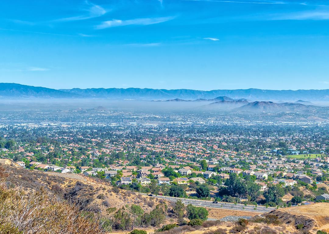 Aerial view of inland California featuring a view of residential homes and hills.