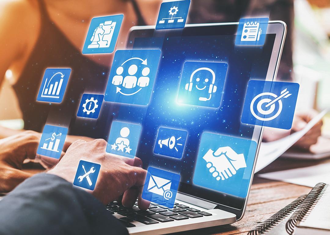 A business analyst managing CRM platforms from a laptop to improve customer relationships through data analysis.