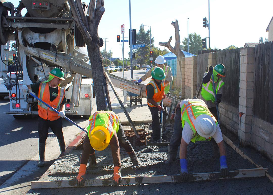 Construction crew doing a sidewalk repair work at day. 
