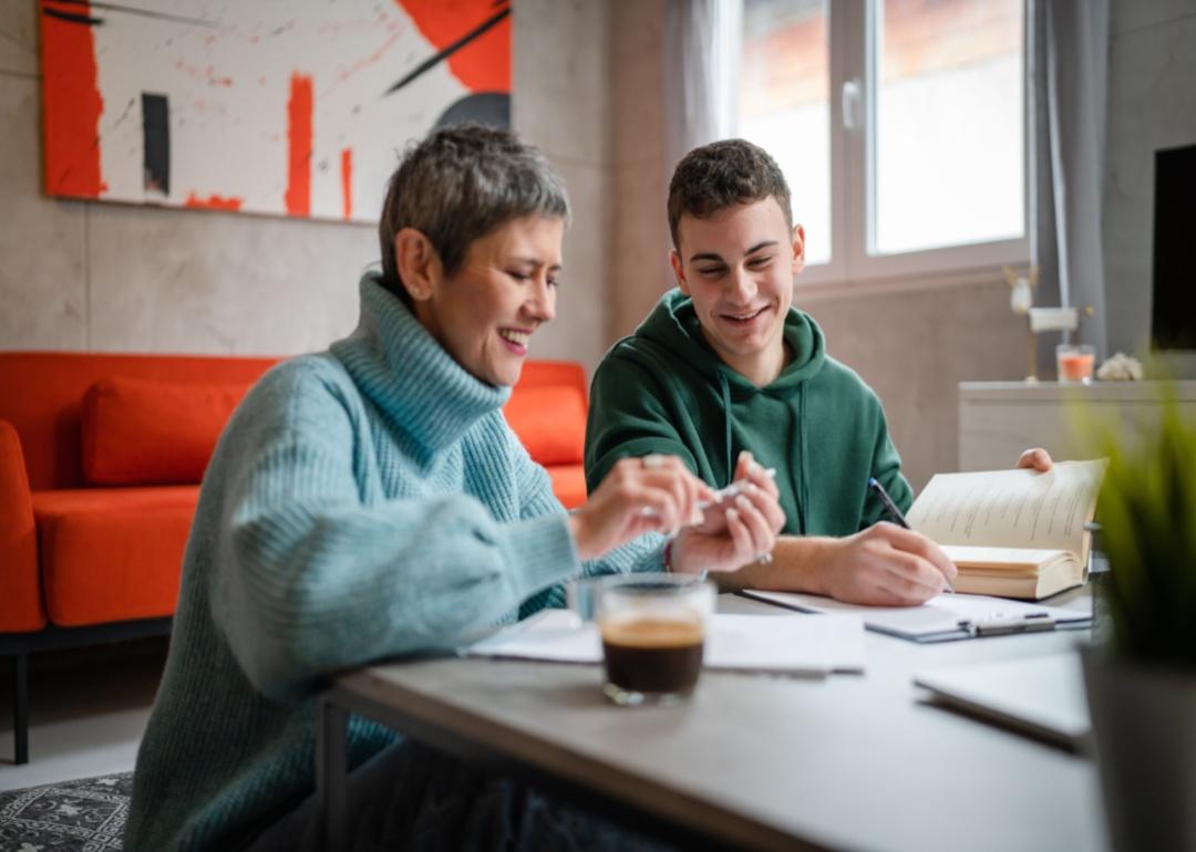 A mother helping her son with paperwork.