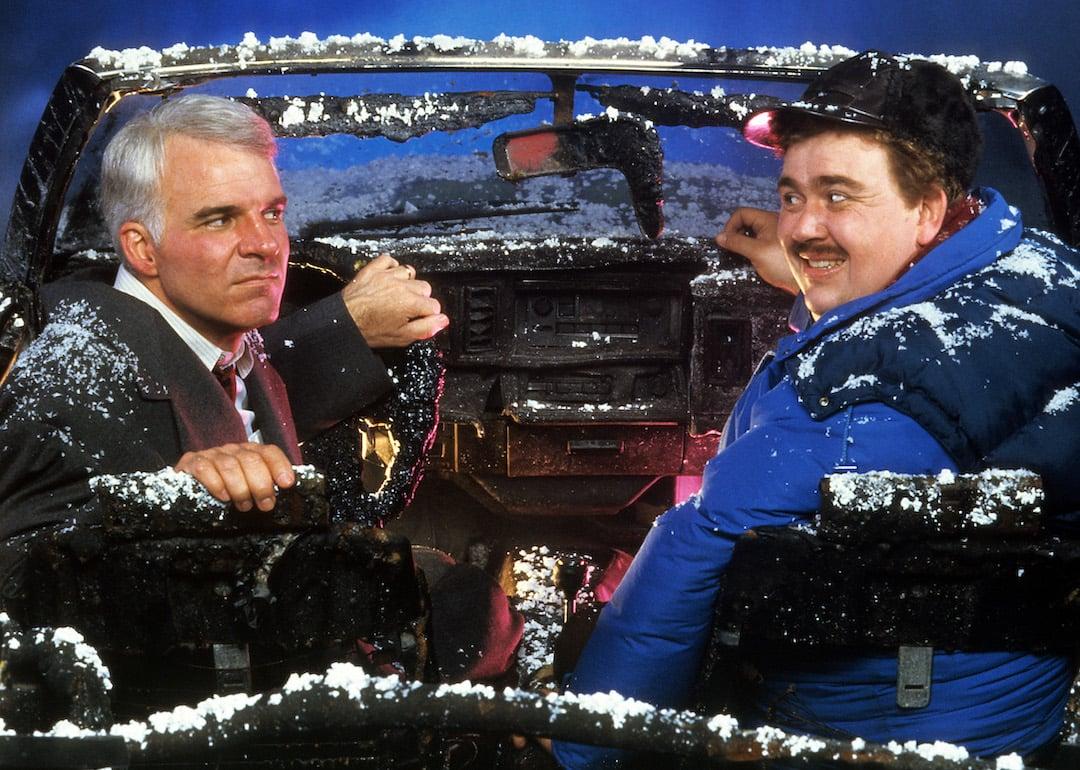 Actors Steve Martin and John Candy sit in a destroyed car in a scene from the 1987 Thanksgiving film 'Planes, Trains & Automobiles.'