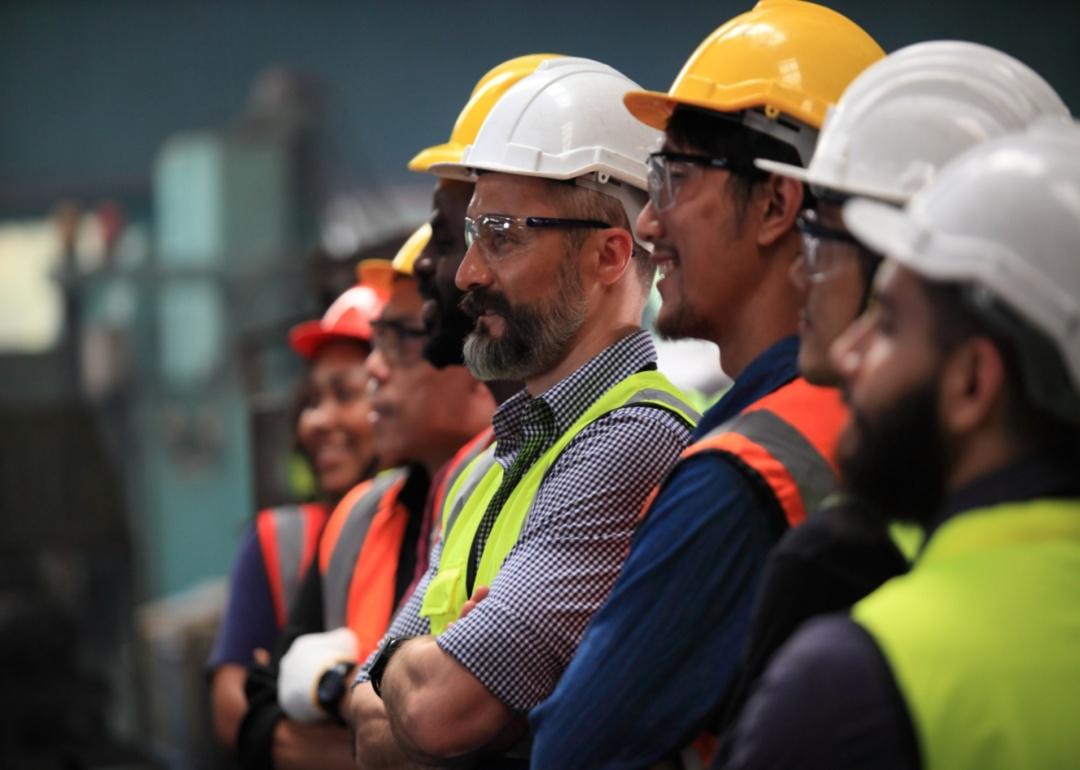 A group of workers in safety vests and helmets.