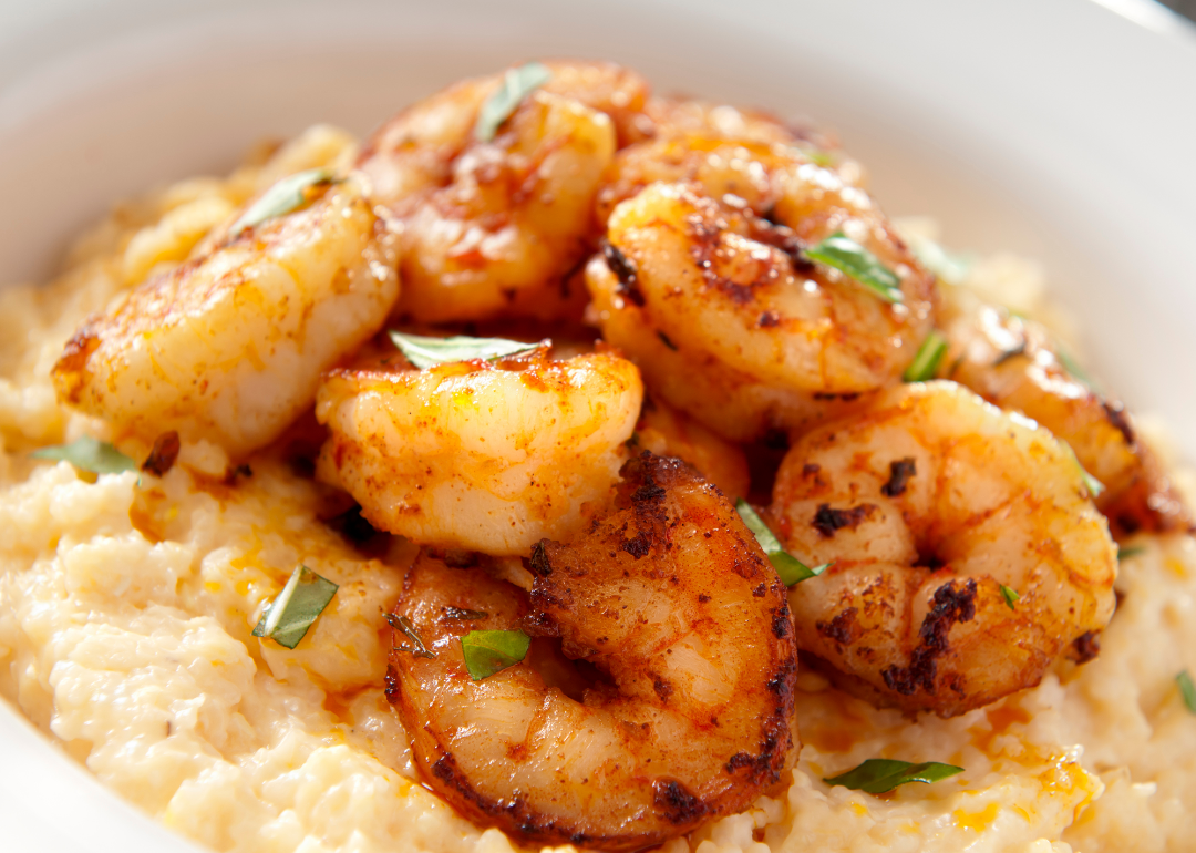 Shrimp and cheese grits in a white bowl.