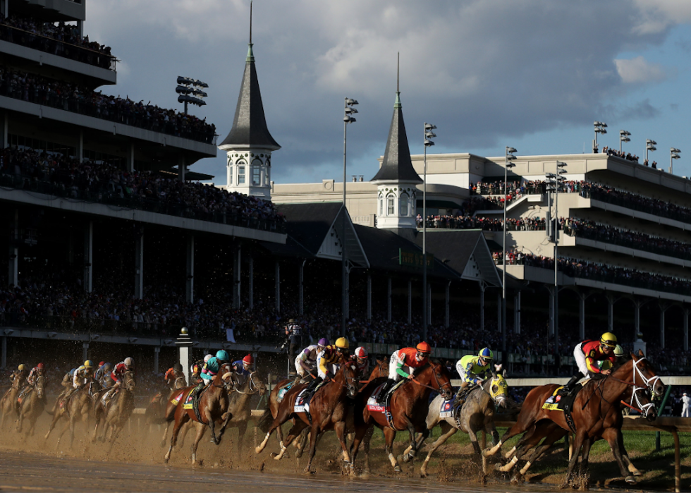 Jockeys and horses rounding a turn