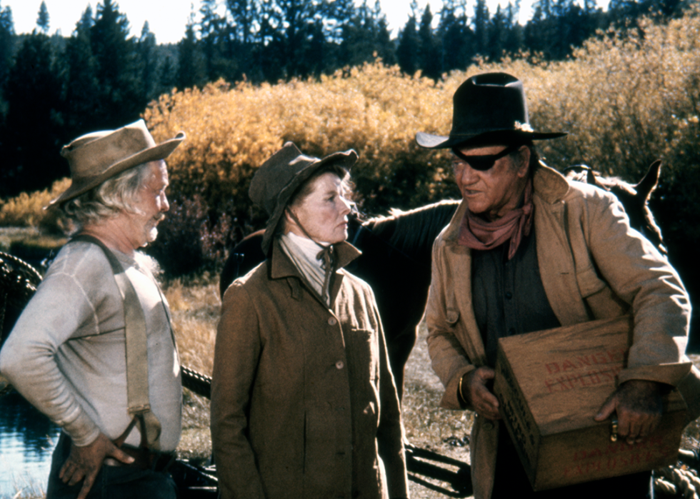 Strother Martin, Katharine Hepburn and John Wayne on the set of ‘Rooster Cogburn’.