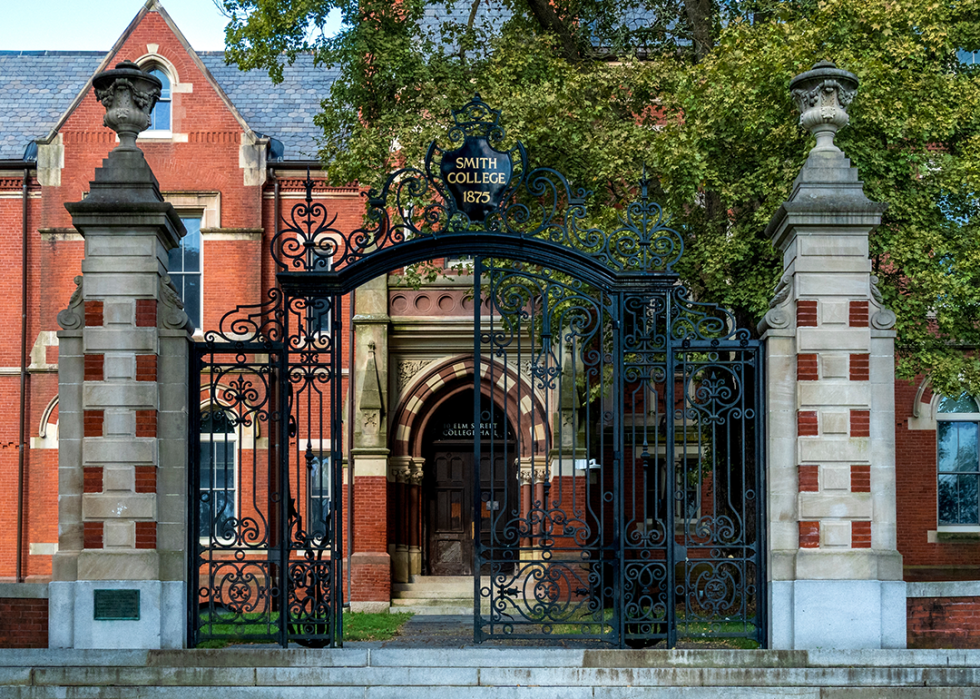Iron gates and stone pillars frame the entrance to College Hall on Smith College campus.