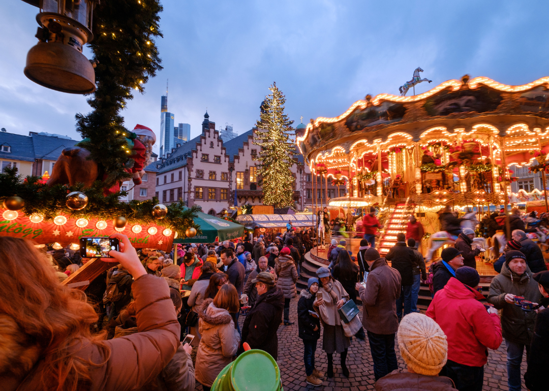 Vistors walk among stalls in Christmas Market in Frankfurt.