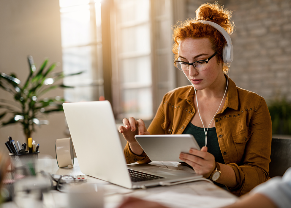 Woman with headphones in office.