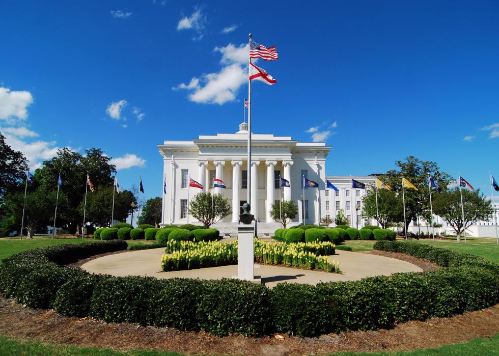 Alabama State Capitol with flags.