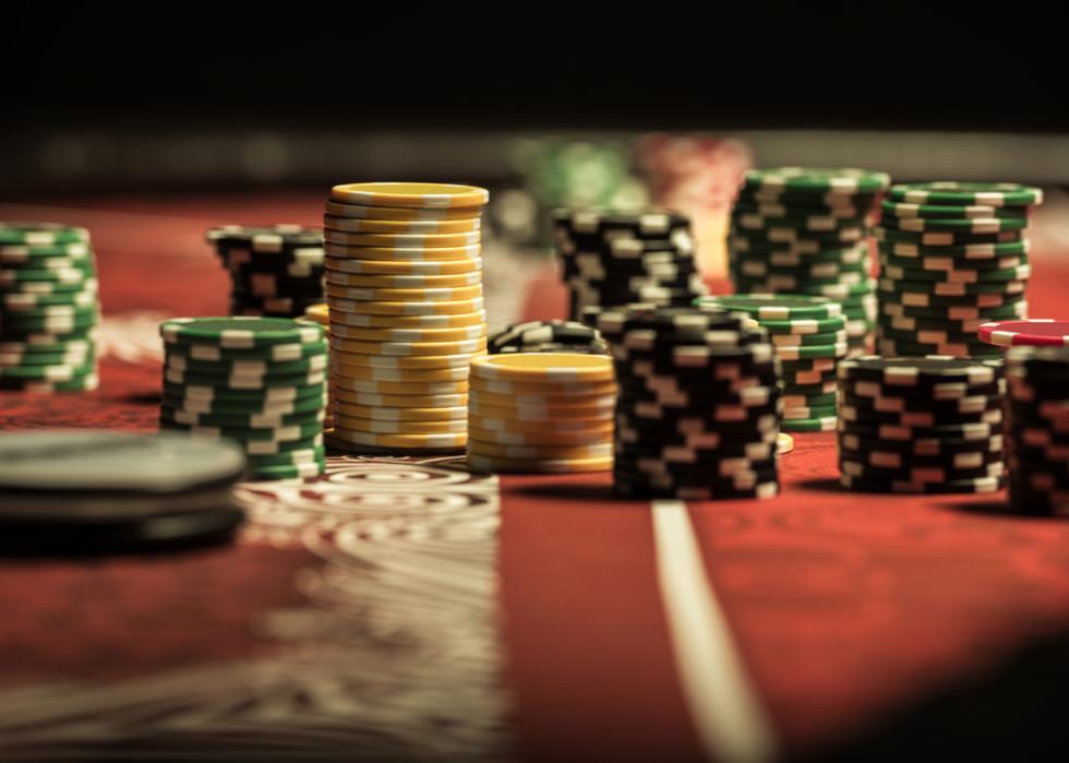 Poker chips on poker table at casino.