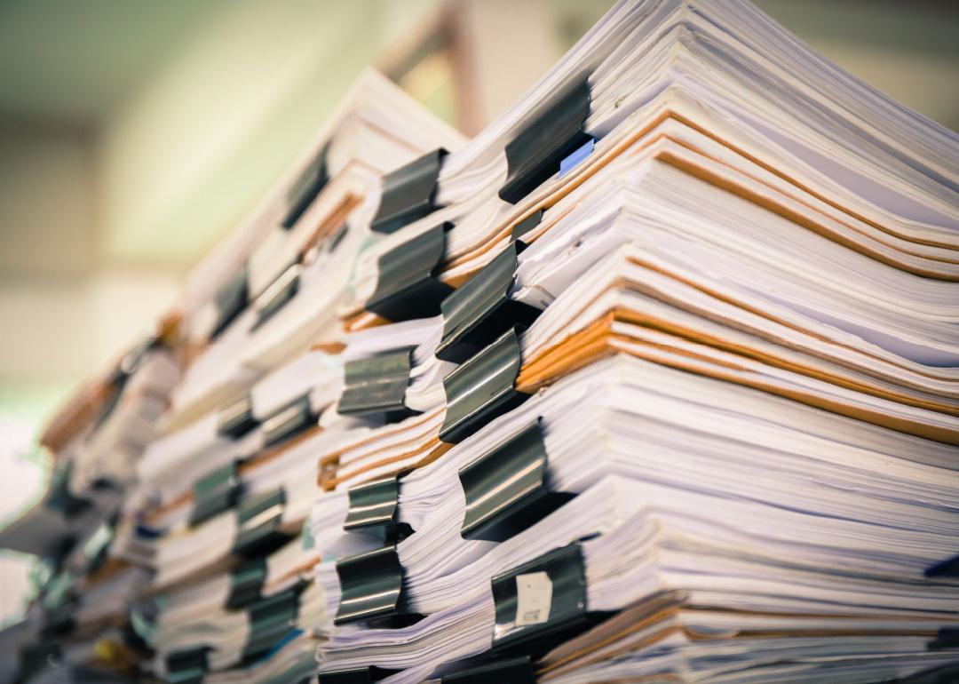 Stacks of documents organized with binder clips