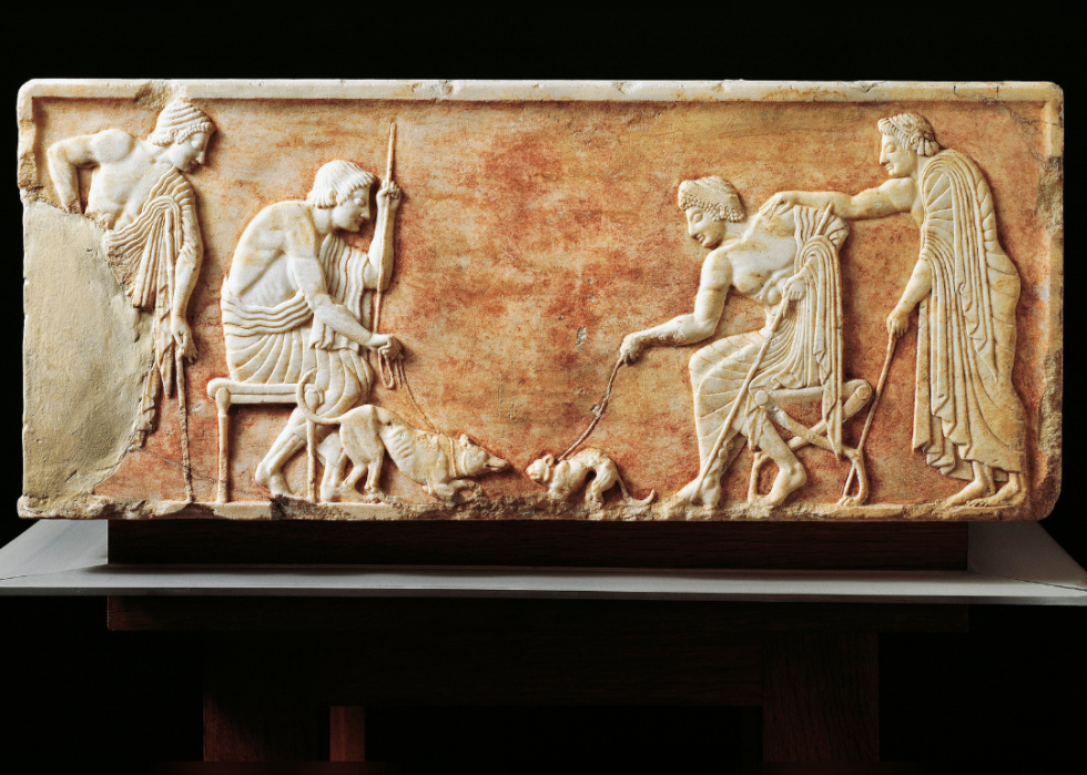 Greek stele depicting a fight between a dog and a cat