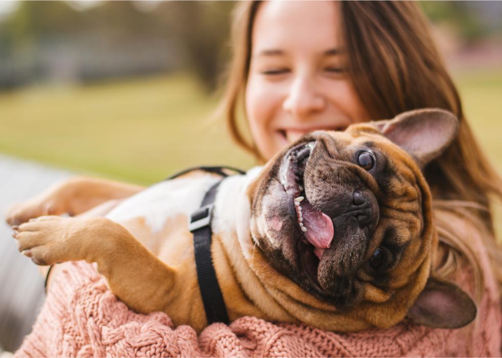 Woman holding happy dog.