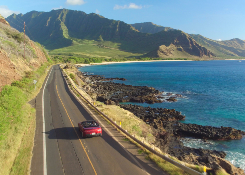 Car driving along coastal road.