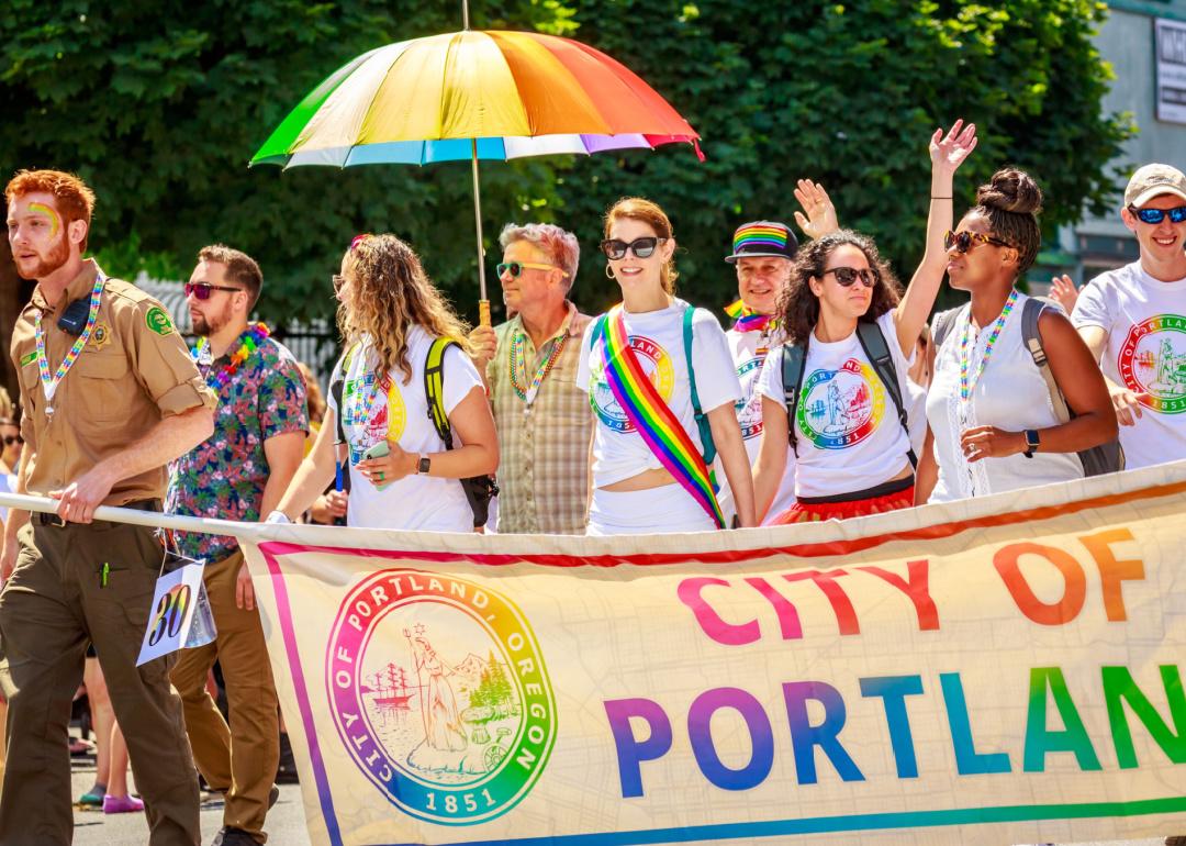 group of people walking with banner Portland’s pride parade