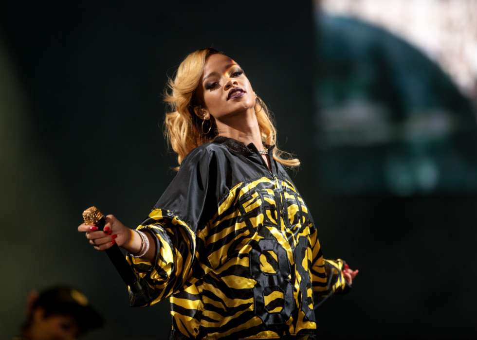 Rihanna dances with microphone onstage.