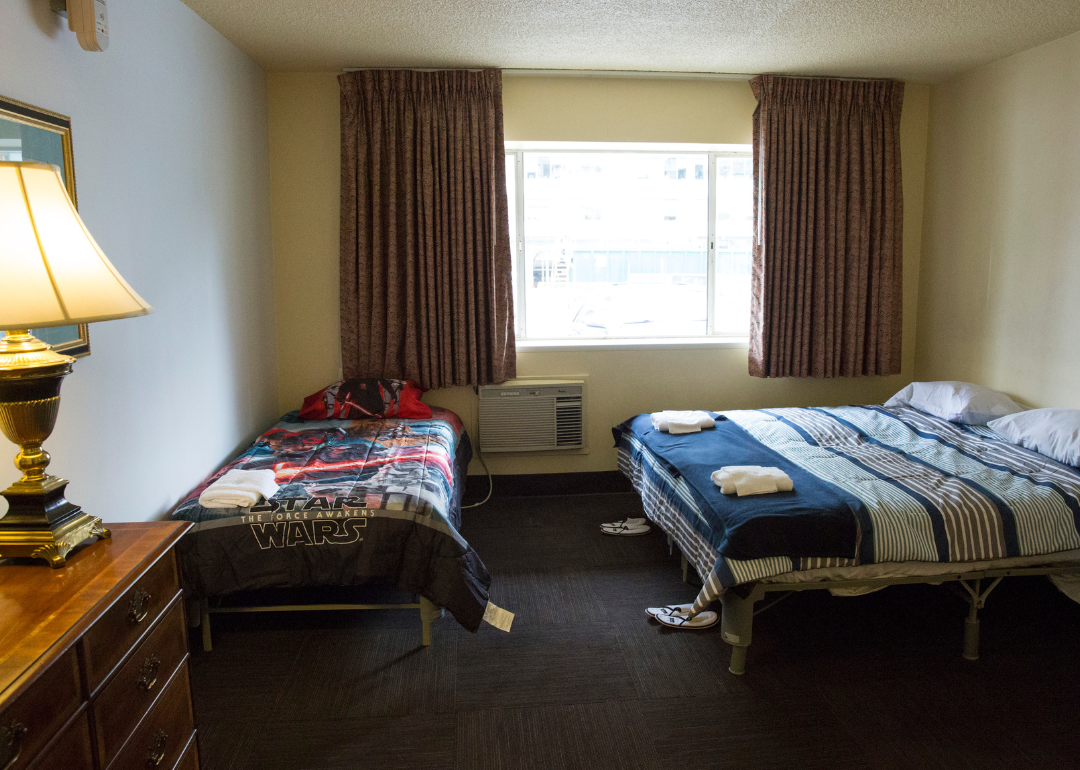 Inside a bedroom with two beds at a former motel housing homeless
