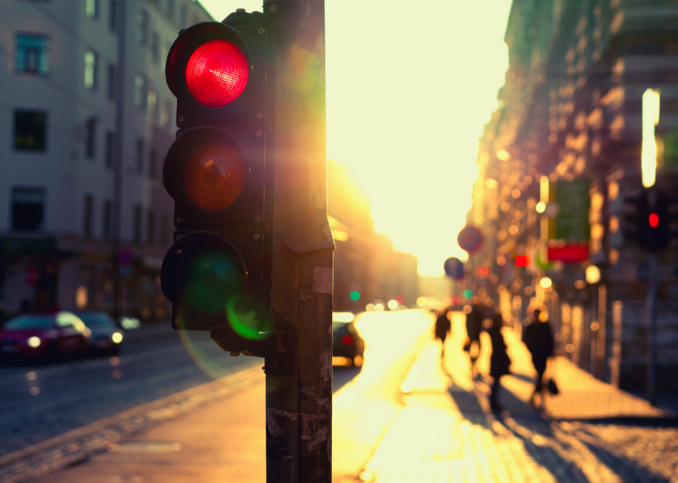 Urban red traffic light at sunset