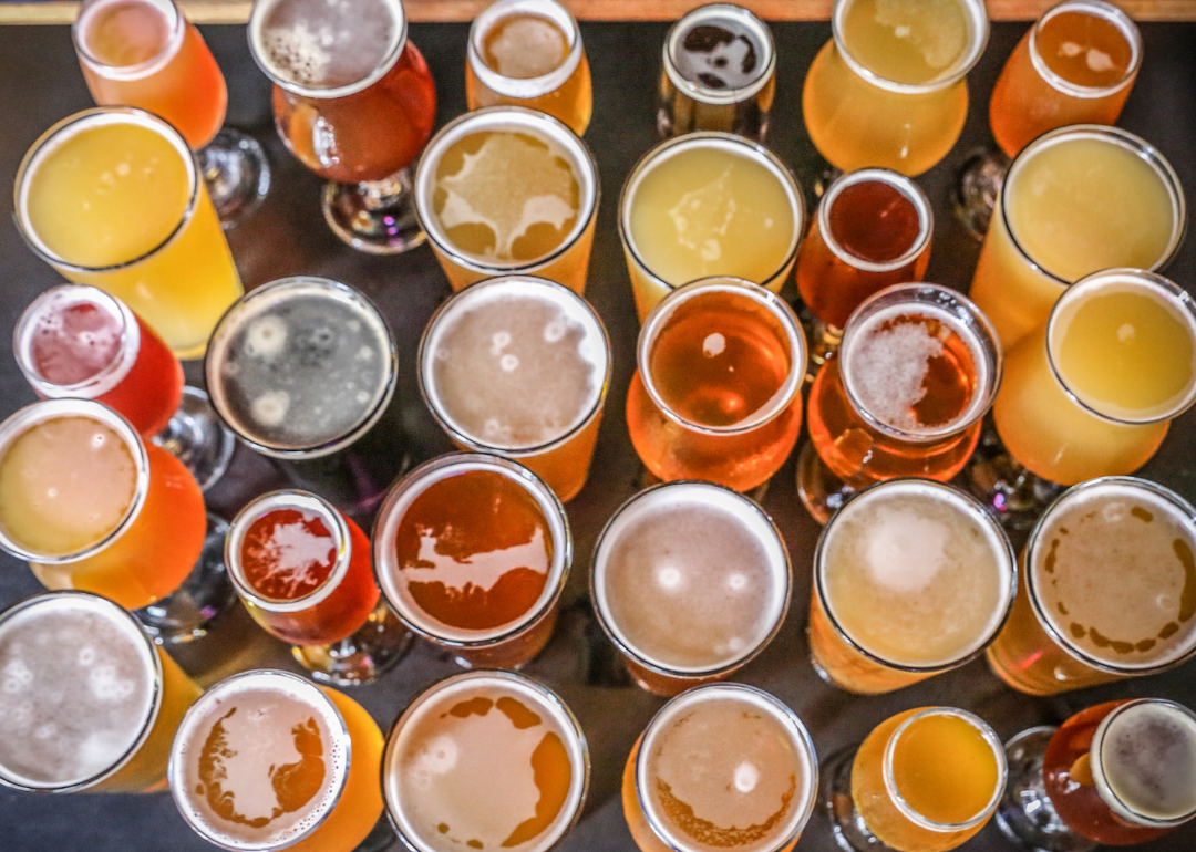 Overhead view of dozens of beer glasses on bar.