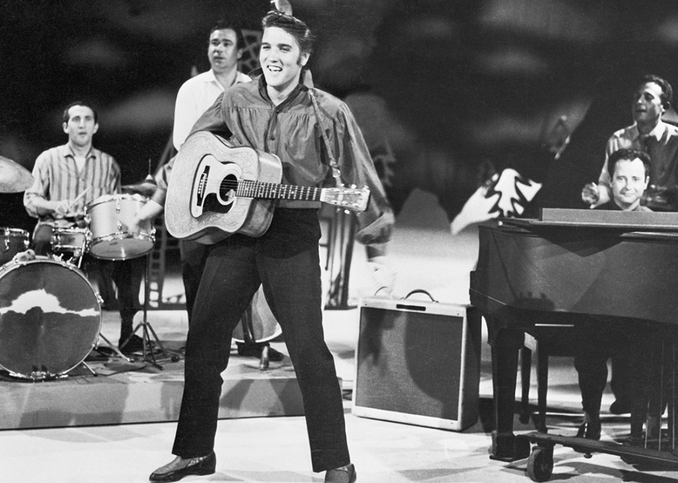 Elvis Presley with guitar rehearses for performance.