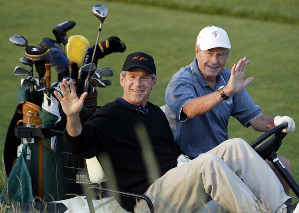 George W. Bush golfs with his father, former President George Herbert Walker Bush, at the Cape Arrundel Golf Club.