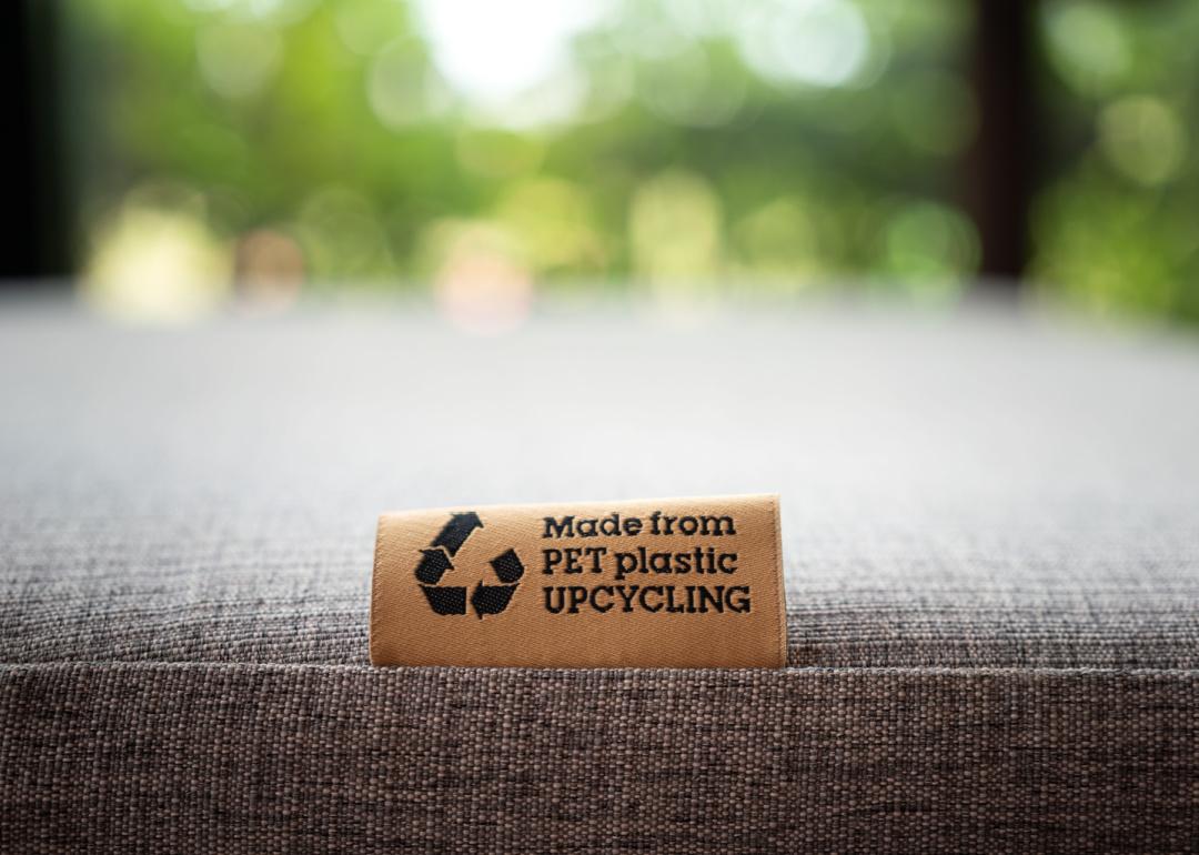 'PET Plastic upcycling' product label tag on the sofa
