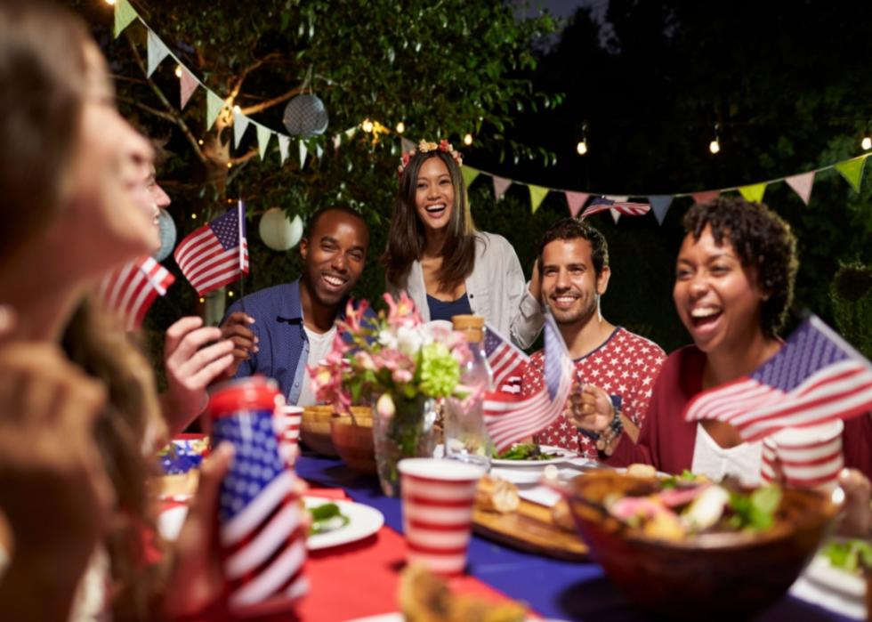 People with patriotic decor having dinner outside.