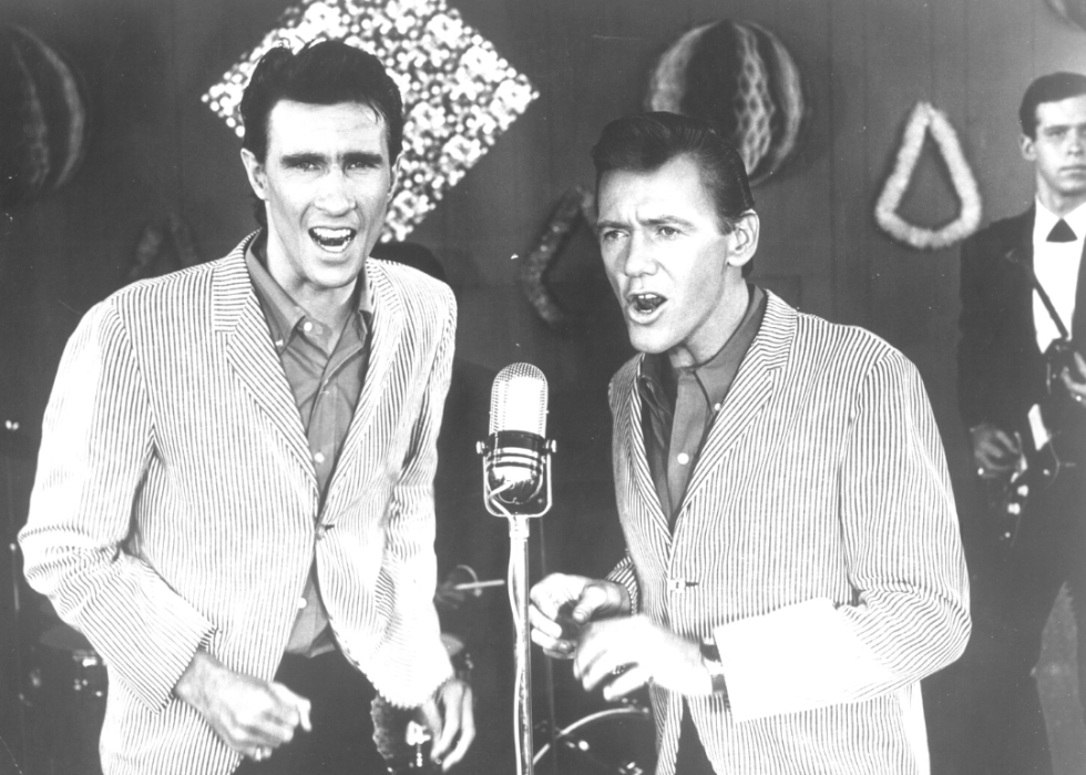 Bobby Hatfield and Bill Medley perform at microphone.