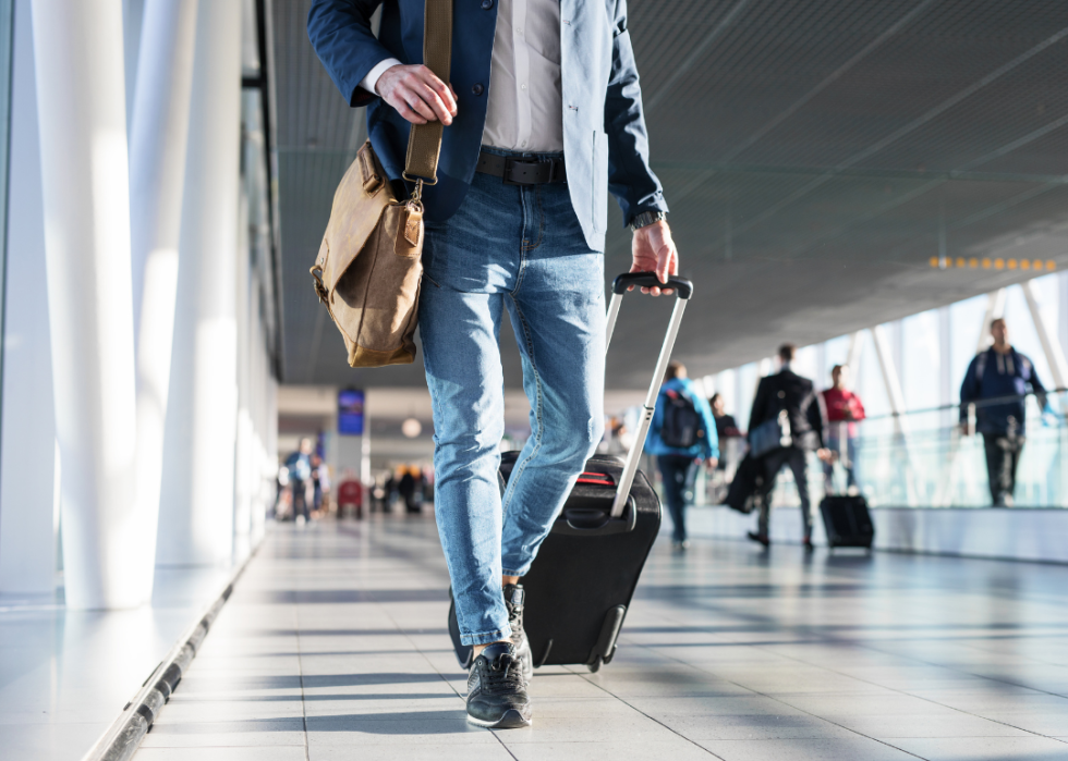 Man with luggage walking in airport terminal