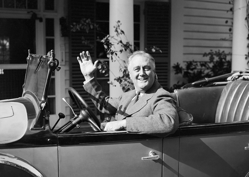 Franklin D. Roosevelt waves from his car at Warm Springs, Georgia.