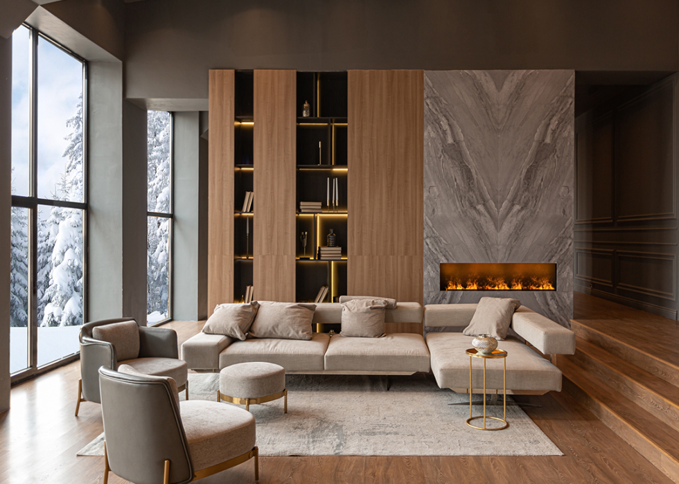 Expansive living room with contemporary furniture and marble wall fireplace.