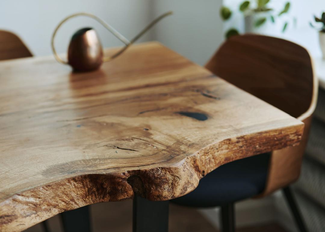 Raw edge oak wooden table detail.
