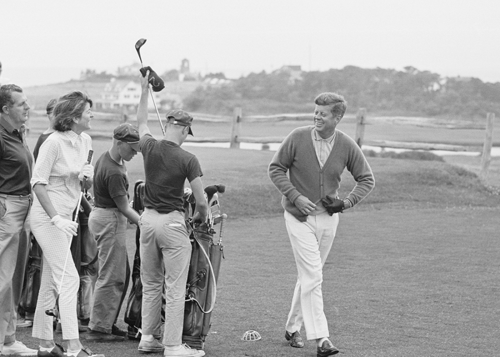 President Kennedy smiles at sister Pat, after driving off the first tee in Hyannisport.