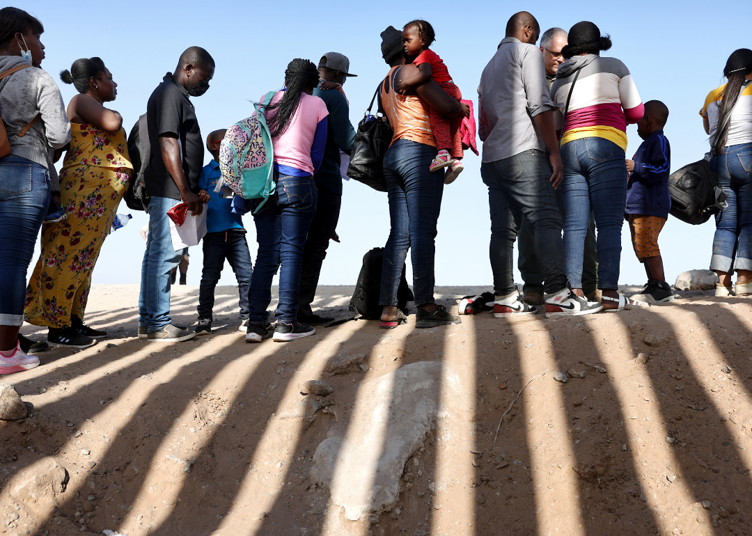 Immigrants wait in line to be processed by the U.S. Border Patrol in Arizona.
