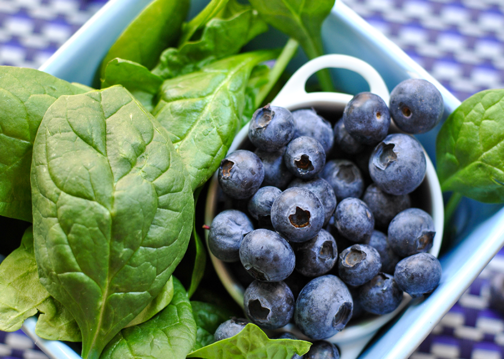 Bowl of spinach and blueberries.