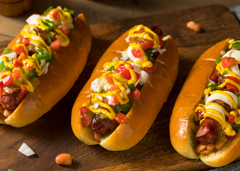 Top view of three Sonoran hot dogs.