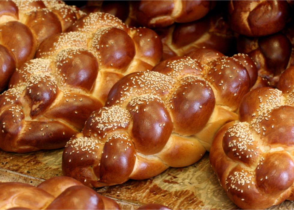 A close up of several loaves of challah.