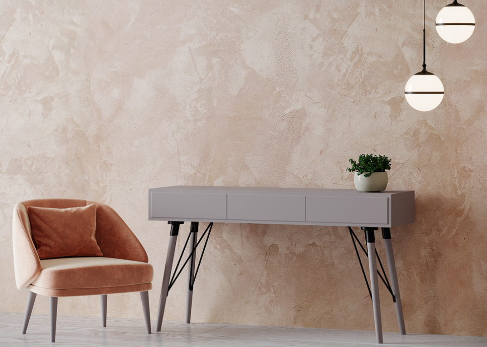 Warm toned venetian plaster wall detail with chair and side table.