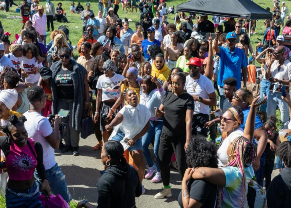 A crowd celebrating Juneteenth at a park.
