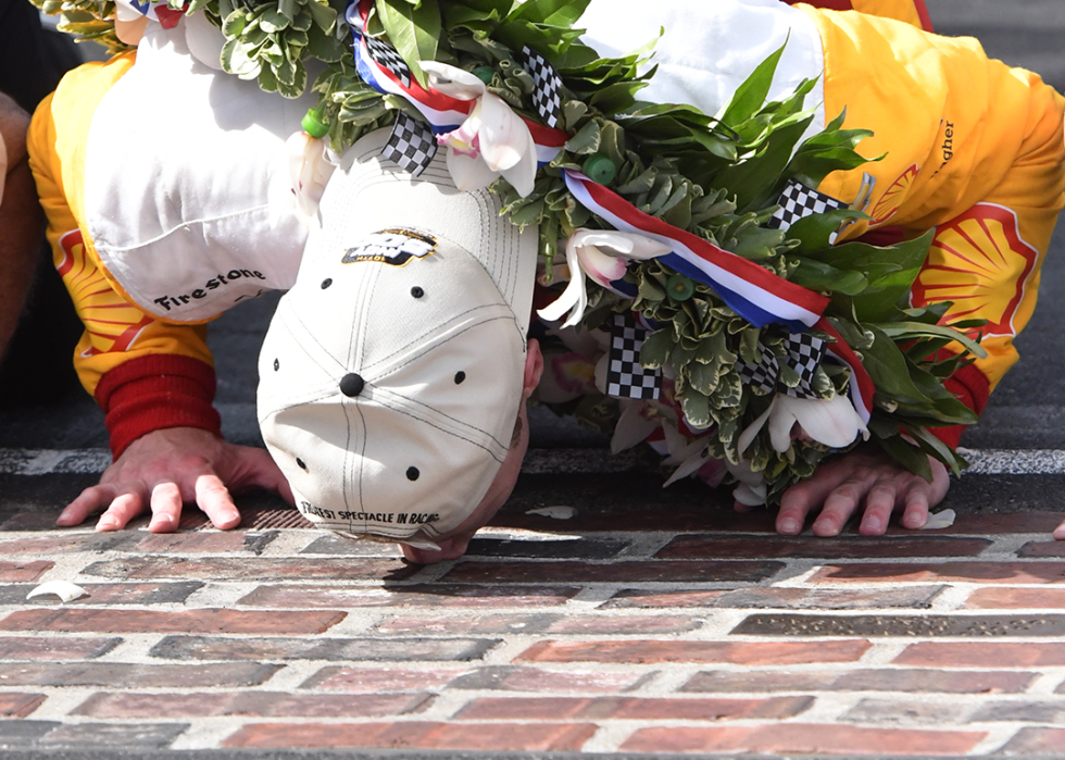 Josef Newgarden kisses the historic IMS Yard of Bricks.