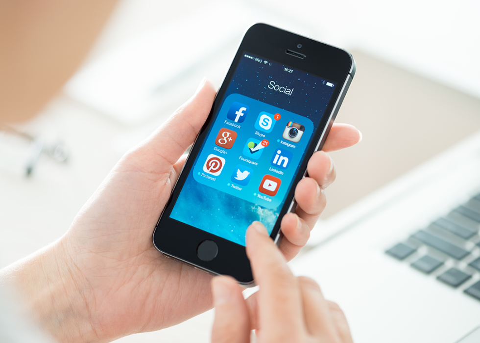 Close-up view of person holding iPhone 5S.