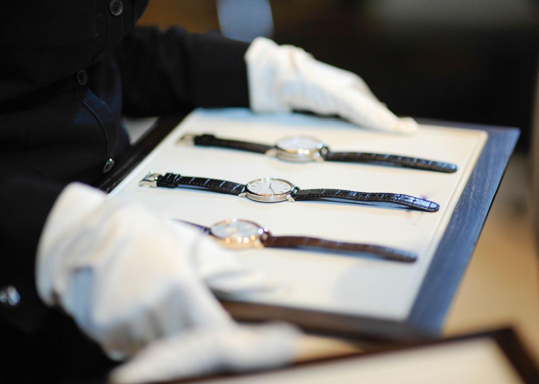 White glove presentation of luxury watches.