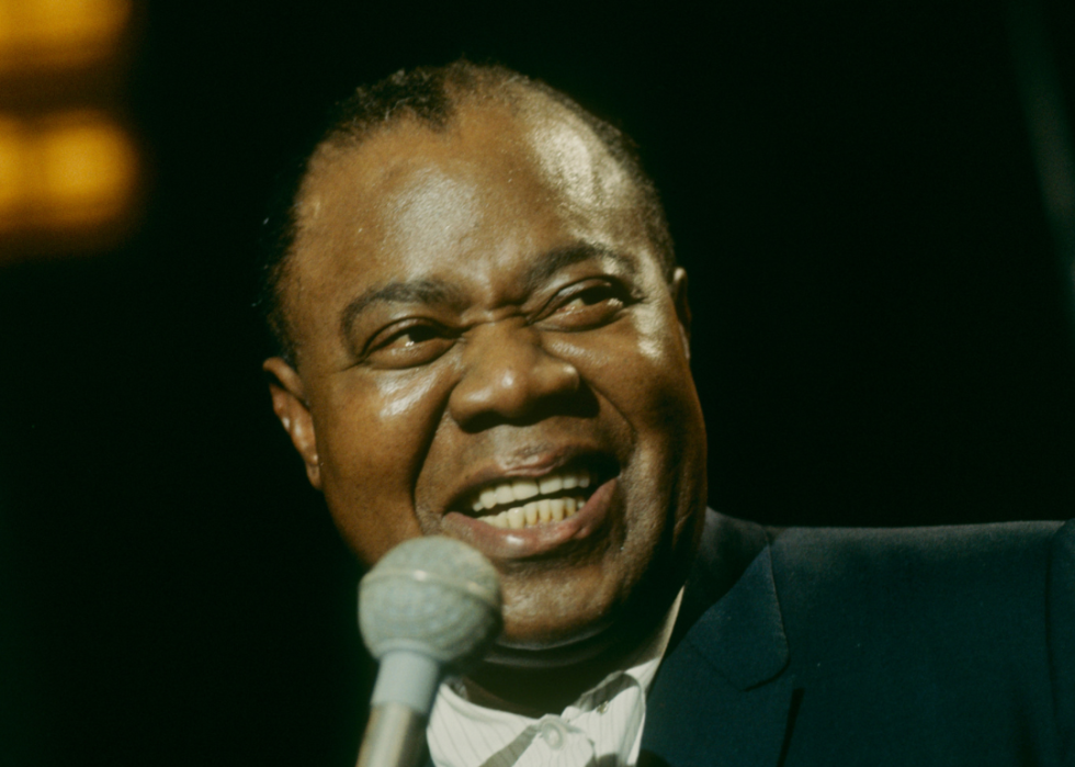 Louis Armstrong with microphone.