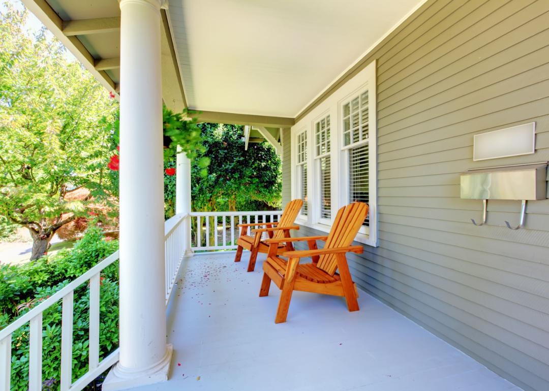 Exterior residential porch with chairs.